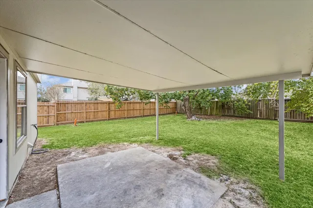 a view of a backyard with grass and plants