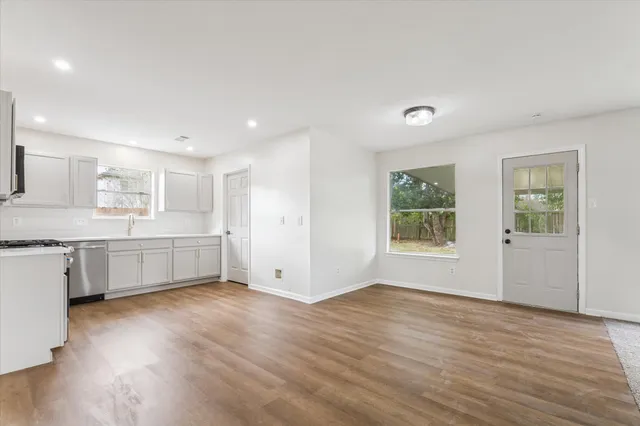 a view of a kitchen and window with wooden floor