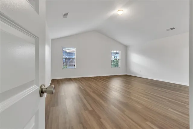 an empty room with windows and entrance