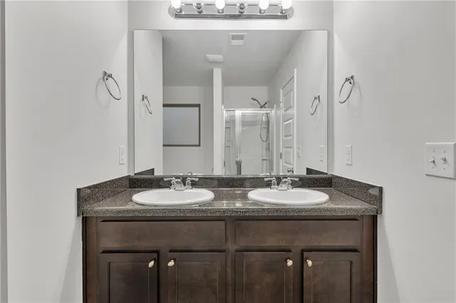 a bathroom with two sink and a mirror