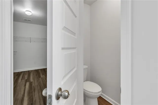a view of a room with wooden floor and window