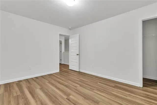 a bathroom with a granite countertop sink toilet and a mirror