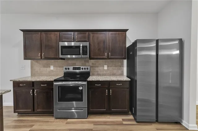 a kitchen with a stove and a microwave