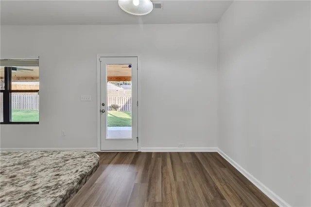 a view of a room with wooden floor and window