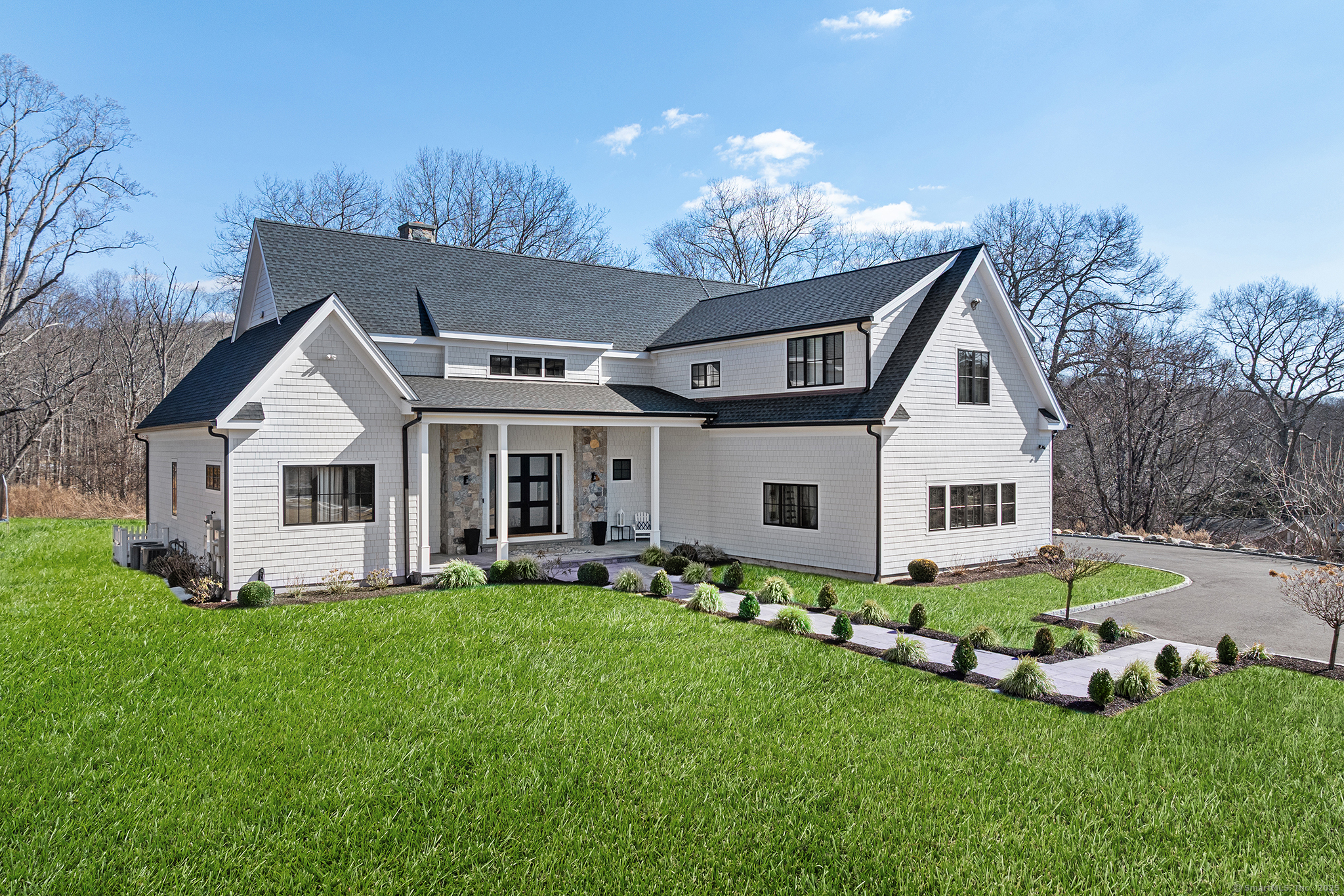a front view of house with a garden and patio