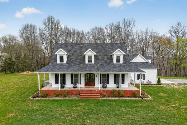 a front view of house with yard and outdoor seating