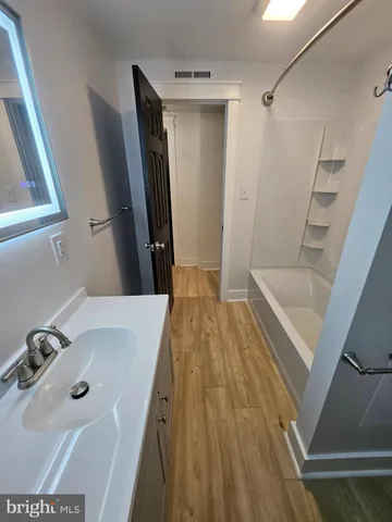 a bathroom with a granite countertop toilet and a shower