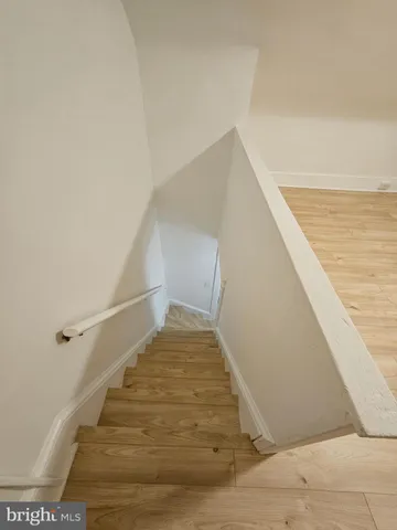 wooden floor with view of empty room