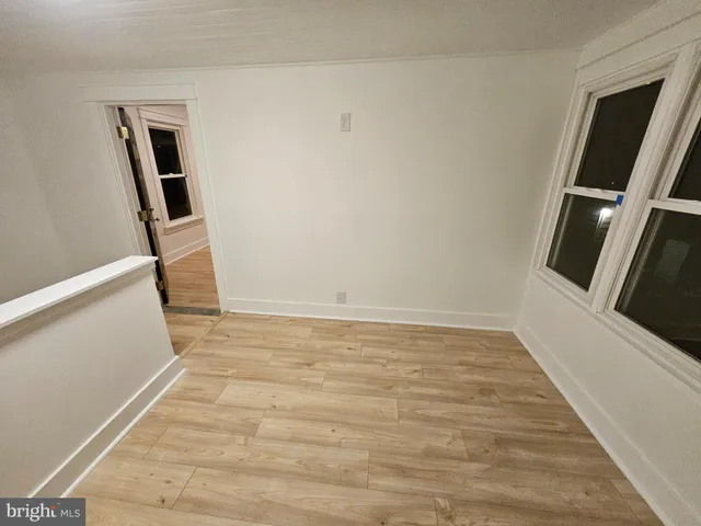 a view of an empty room and wooden floor