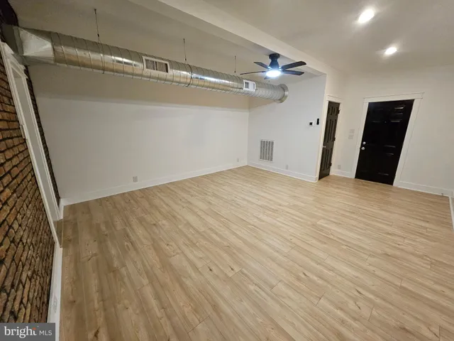 a view of a room with wooden floor