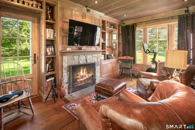 a living room with furniture fireplace and flat screen tv