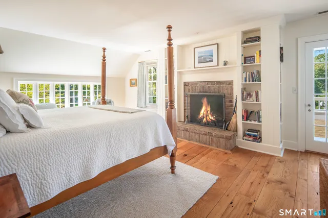 a bedroom with a bed and a fireplace