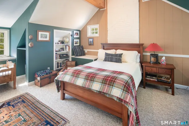 a bedroom with a bed and dresser in it