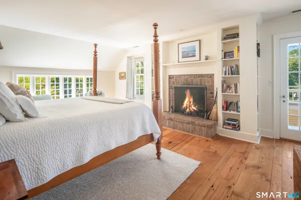 a bedroom with a bed and a fireplace