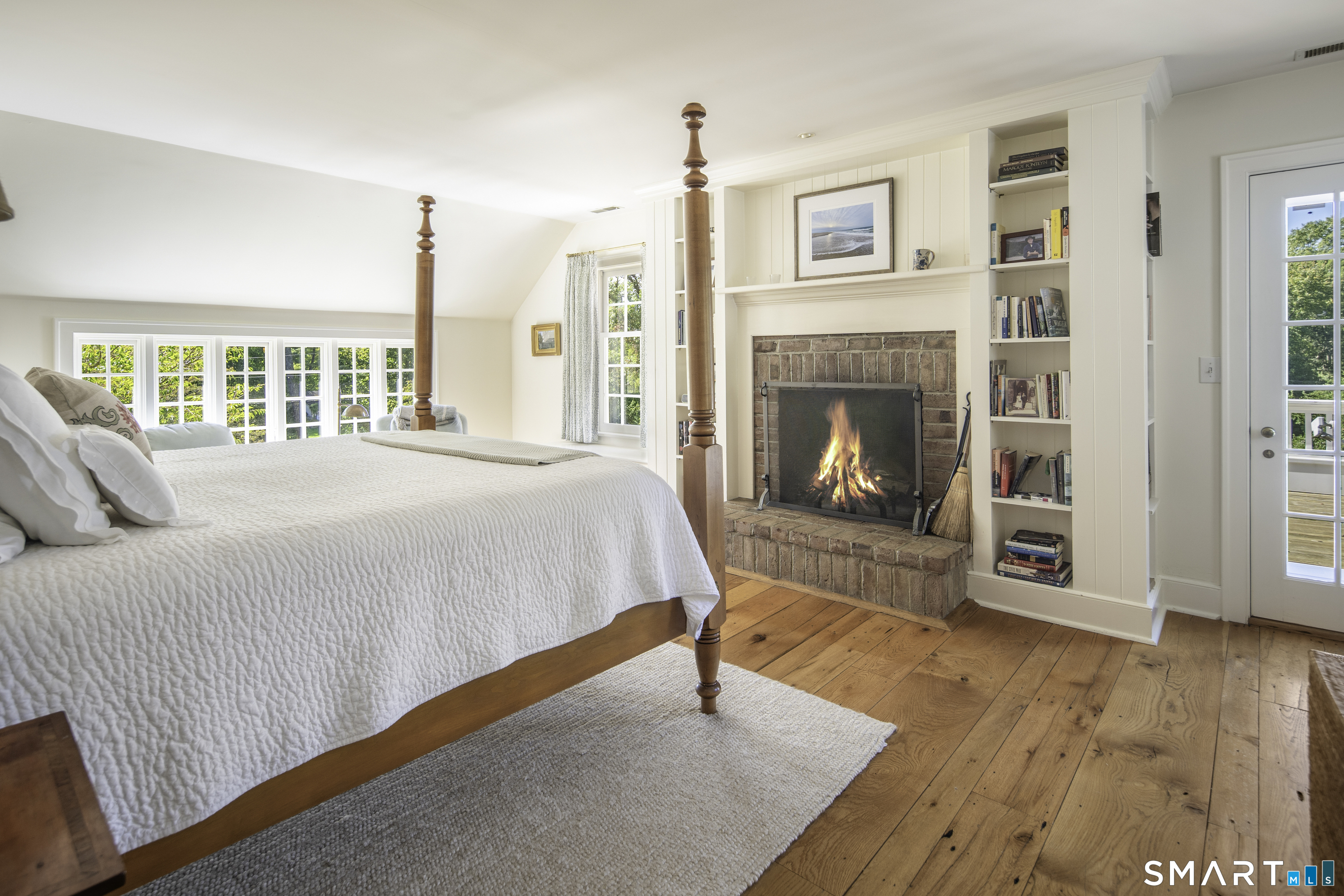 198 Hemlock Hill Road New Canaan, CT 06840 - Photo 23 of 32 a bedroom with a bed and a fireplace