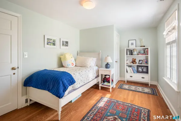 a bedroom with a bed and a book shelf