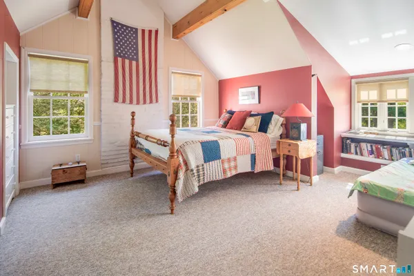 a spacious bedroom with a bed and a large window