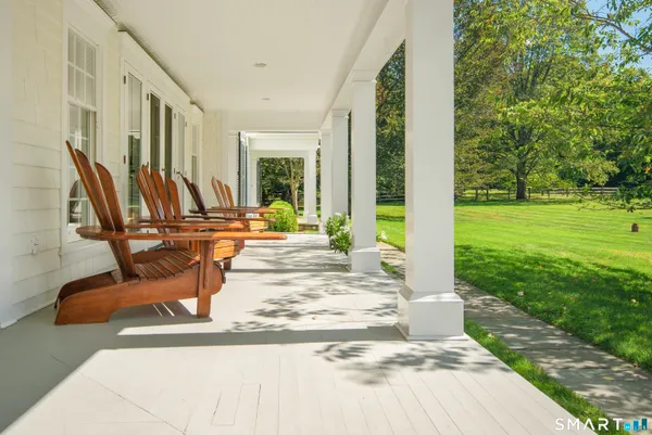 a view of a patio with chairs and plants