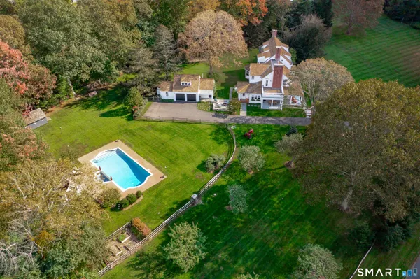 an aerial view of a house with garden space trees and houses