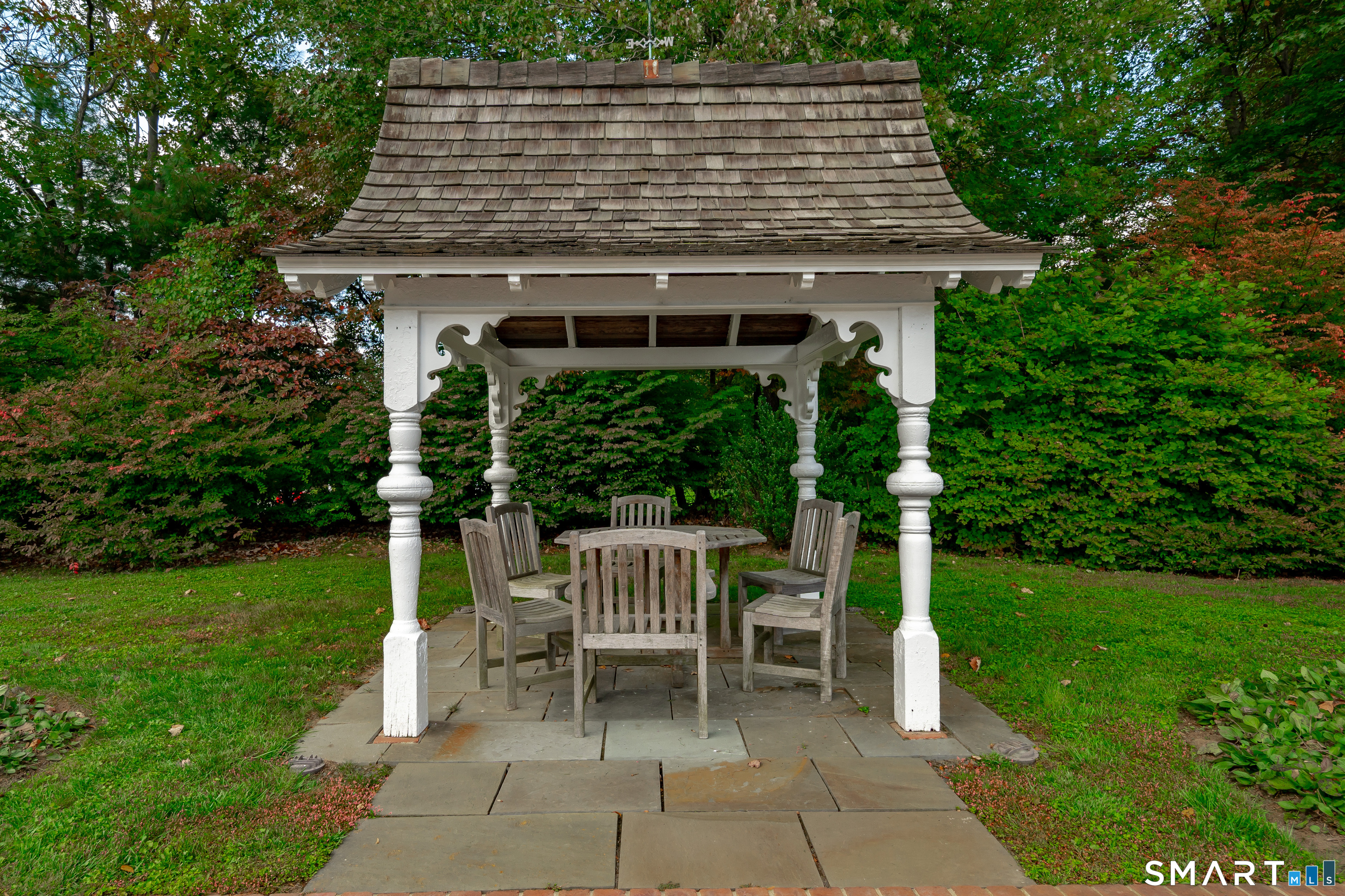 198 Hemlock Hill Road New Canaan, CT 06840 - Photo 9 of 32 a view of a chair and table in the garden