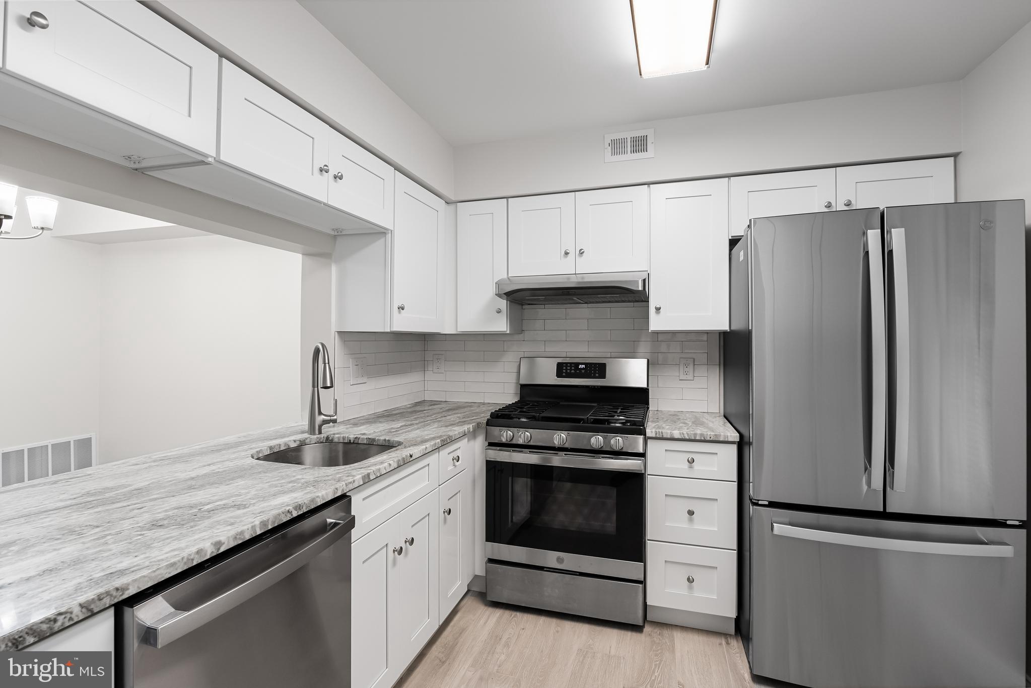 5003 A Albridge Way Mount Laurel, NJ 08054 - Photo 13 of 28 a kitchen with granite countertop a sink stove and refrigerator