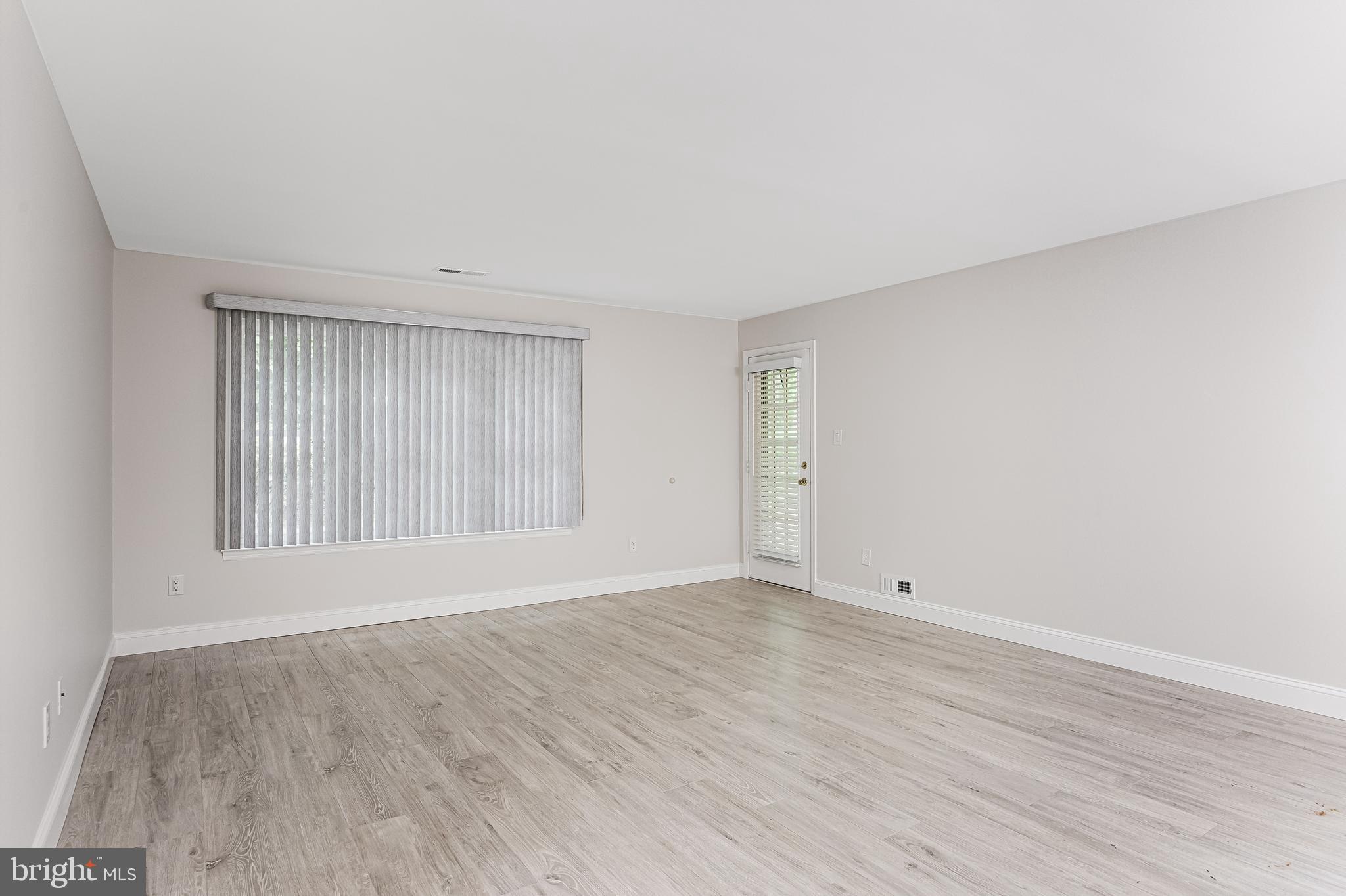 5003 A Albridge Way Mount Laurel, NJ 08054 - Photo 7 of 28 a view of an empty room with wooden floor and a window