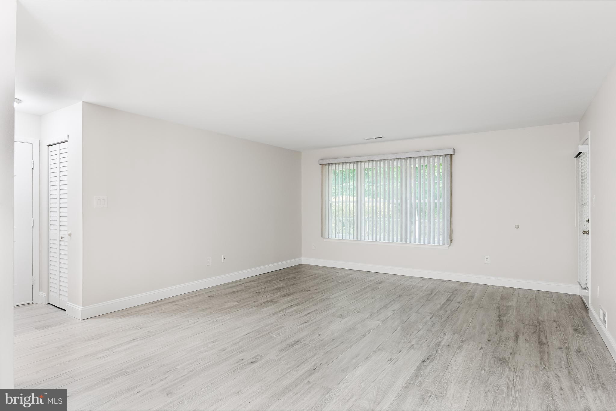 5003 A Albridge Way Mount Laurel, NJ 08054 - Photo 8 of 28 a view of an empty room with wooden floor and a window