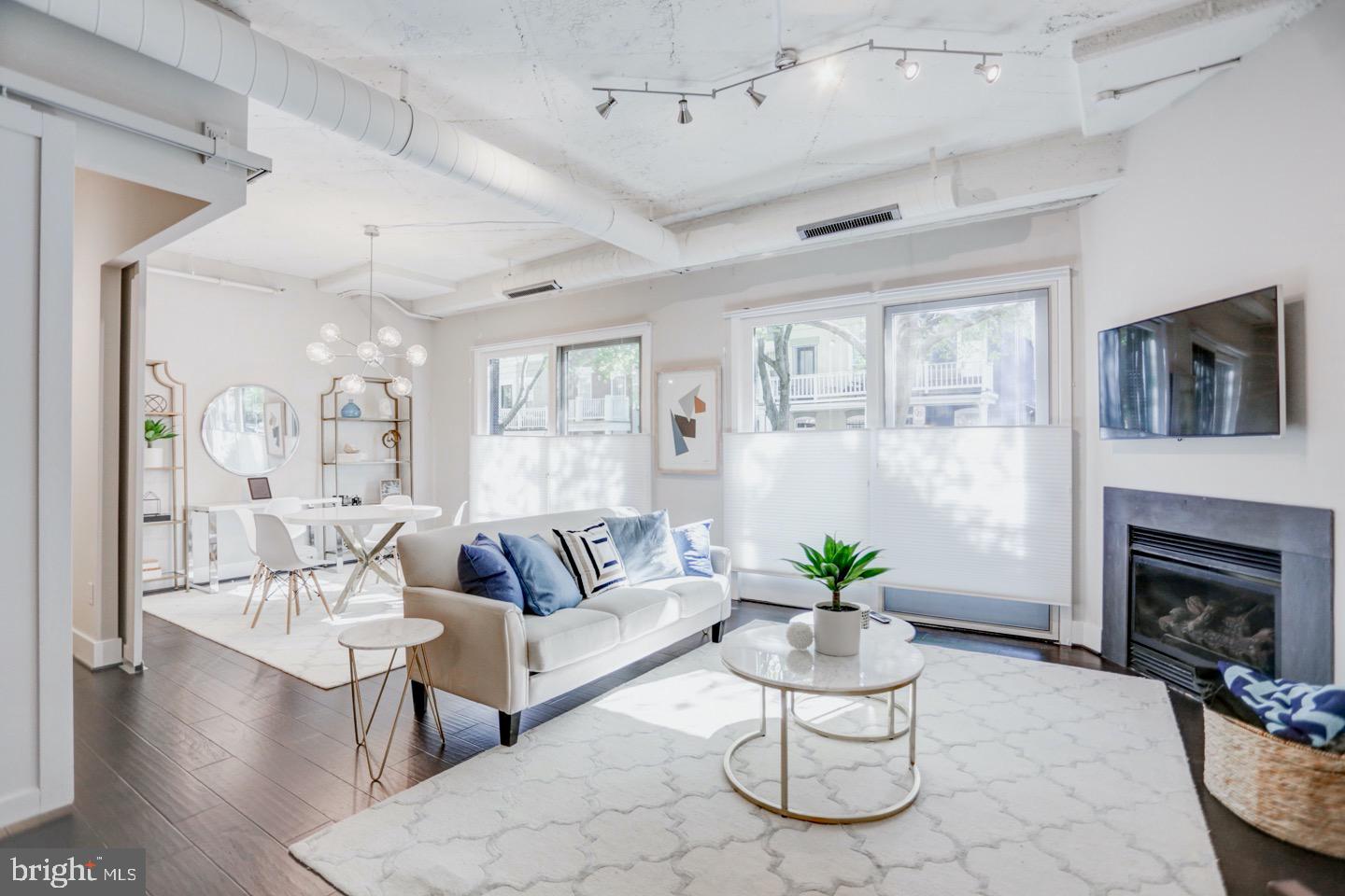 1700 Kalorama Road Northwest, Unit 207 Washington, DC 20009 - Photo 1 of 34 a living room with furniture and a fireplace