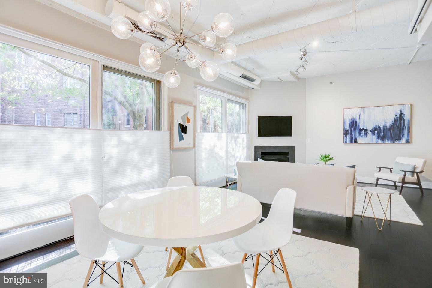 1700 Kalorama Road Northwest, Unit 207 Washington, DC 20009 - Photo 12 of 34 a view of a dining room with furniture a chandelier a rug and wooden floor