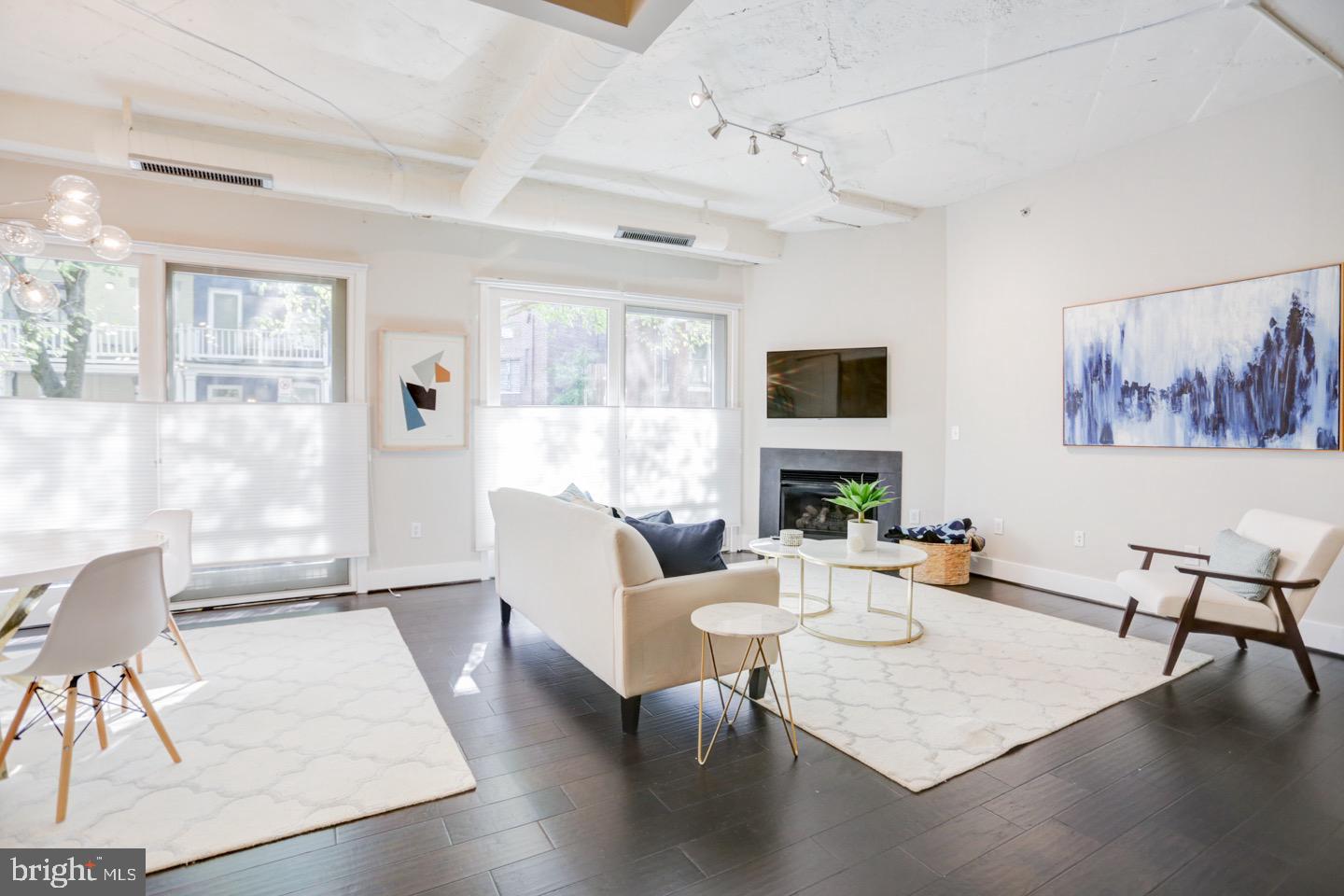 1700 Kalorama Road Northwest, Unit 207 Washington, DC 20009 - Photo 15 of 34 a living room with fireplace furniture and a large window