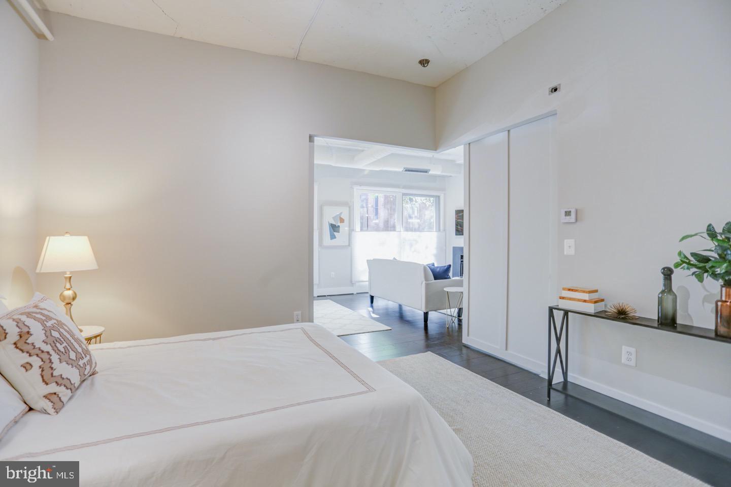 1700 Kalorama Road Northwest, Unit 207 Washington, DC 20009 - Photo 18 of 34 a bedroom with a bed and a lamp on dresser