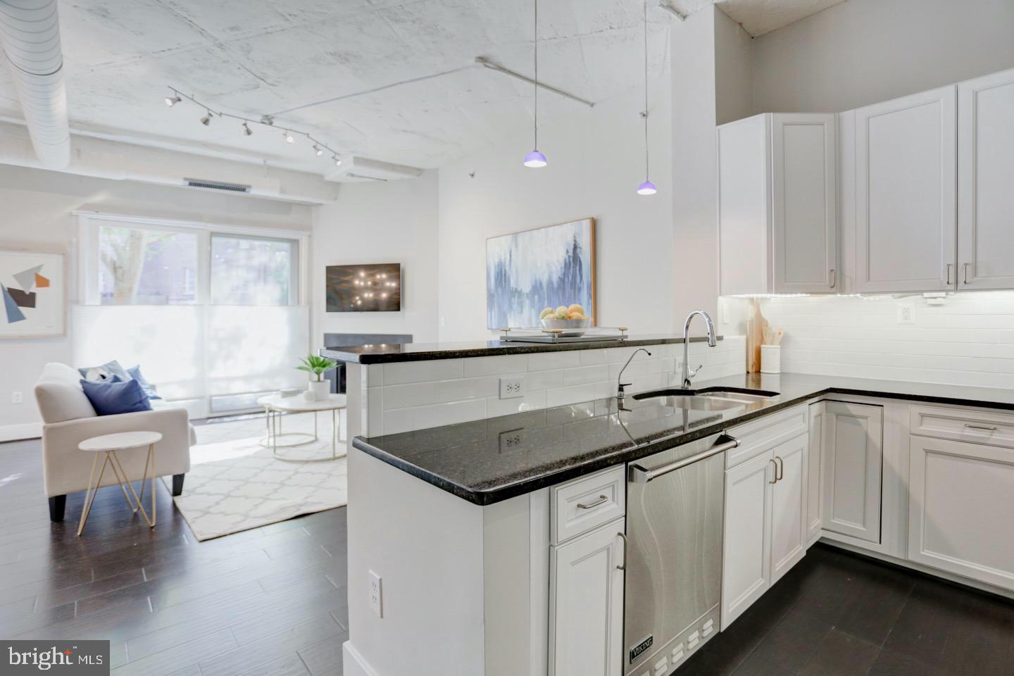 1700 Kalorama Road Northwest, Unit 207 Washington, DC 20009 - Photo 4 of 34 a kitchen with granite countertop a sink a stove cabinets and wooden floor