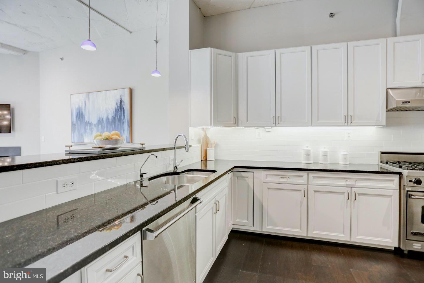 1700 Kalorama Road Northwest, Unit 207 Washington, DC 20009 - Photo 6 of 34 a kitchen with granite countertop white cabinets and sink