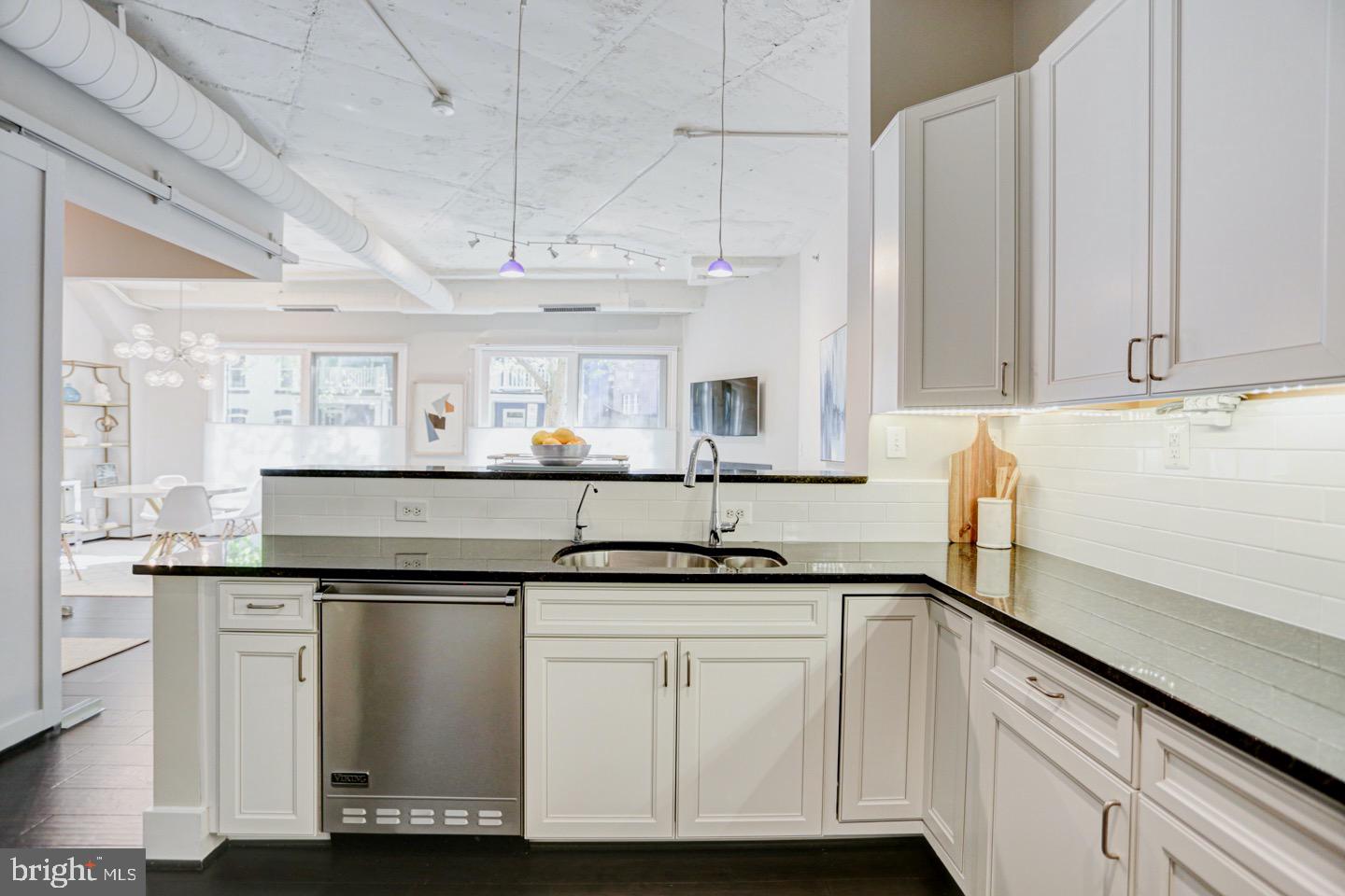 1700 Kalorama Road Northwest, Unit 207 Washington, DC 20009 - Photo 8 of 34 a kitchen with granite countertop a sink and cabinets