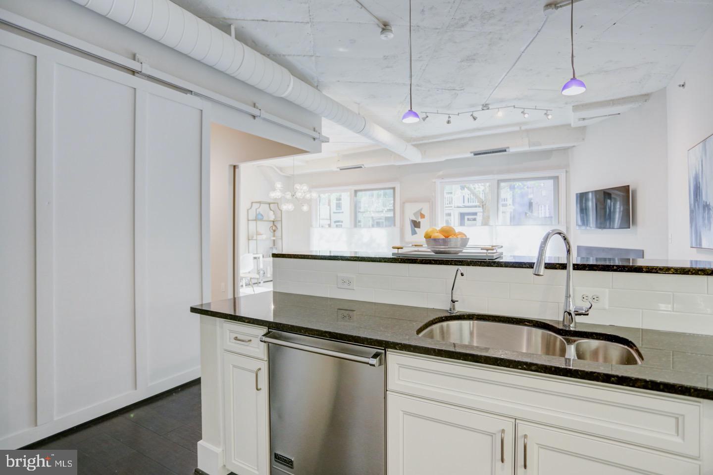 1700 Kalorama Road Northwest, Unit 207 Washington, DC 20009 - Photo 9 of 34 a kitchen with stainless steel appliances granite countertop a sink and a refrigerator