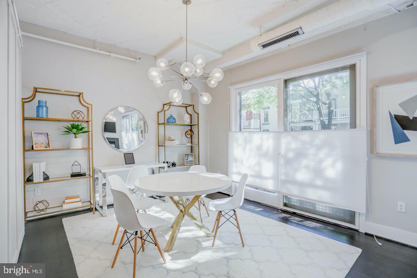 1700 Kalorama Road Northwest, Unit 207 Washington, DC 20009 - Photo 10 of 34 a view of a dining room with furniture window and wooden floor