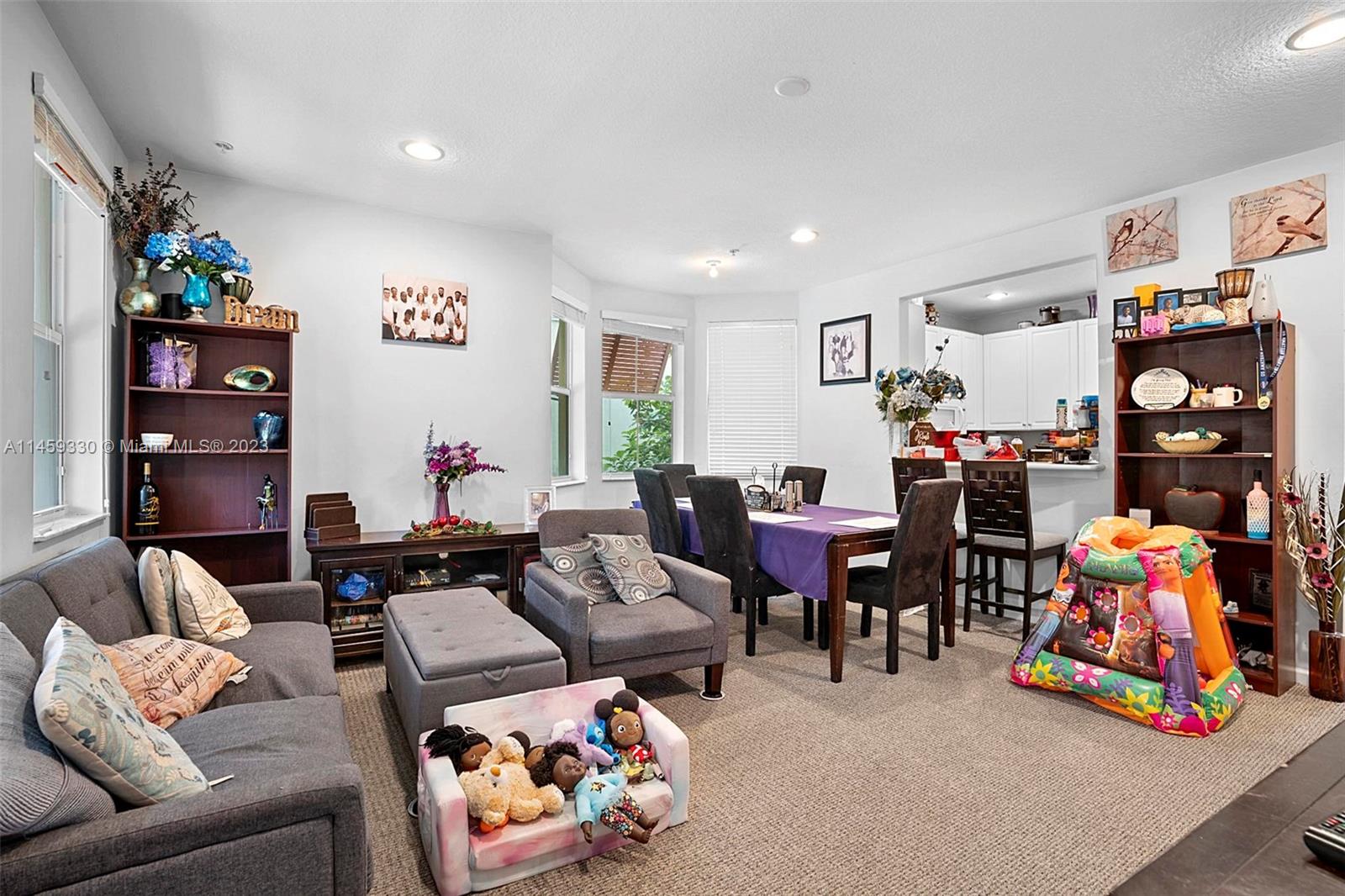 3920 Passion Flower Road Coconut Creek, FL 33073 - Photo 11 of 37 a living room with lots of furniture and a bed