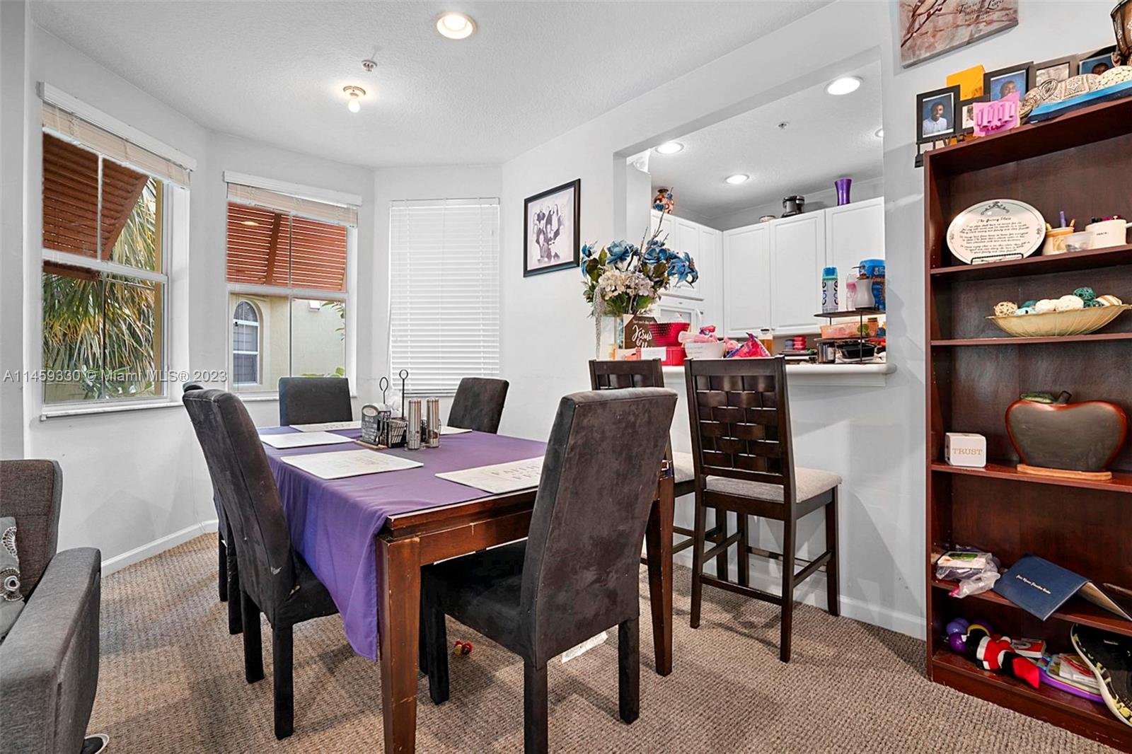3920 Passion Flower Road Coconut Creek, FL 33073 - Photo 12 of 37 a view of a dining room with furniture and chandelier