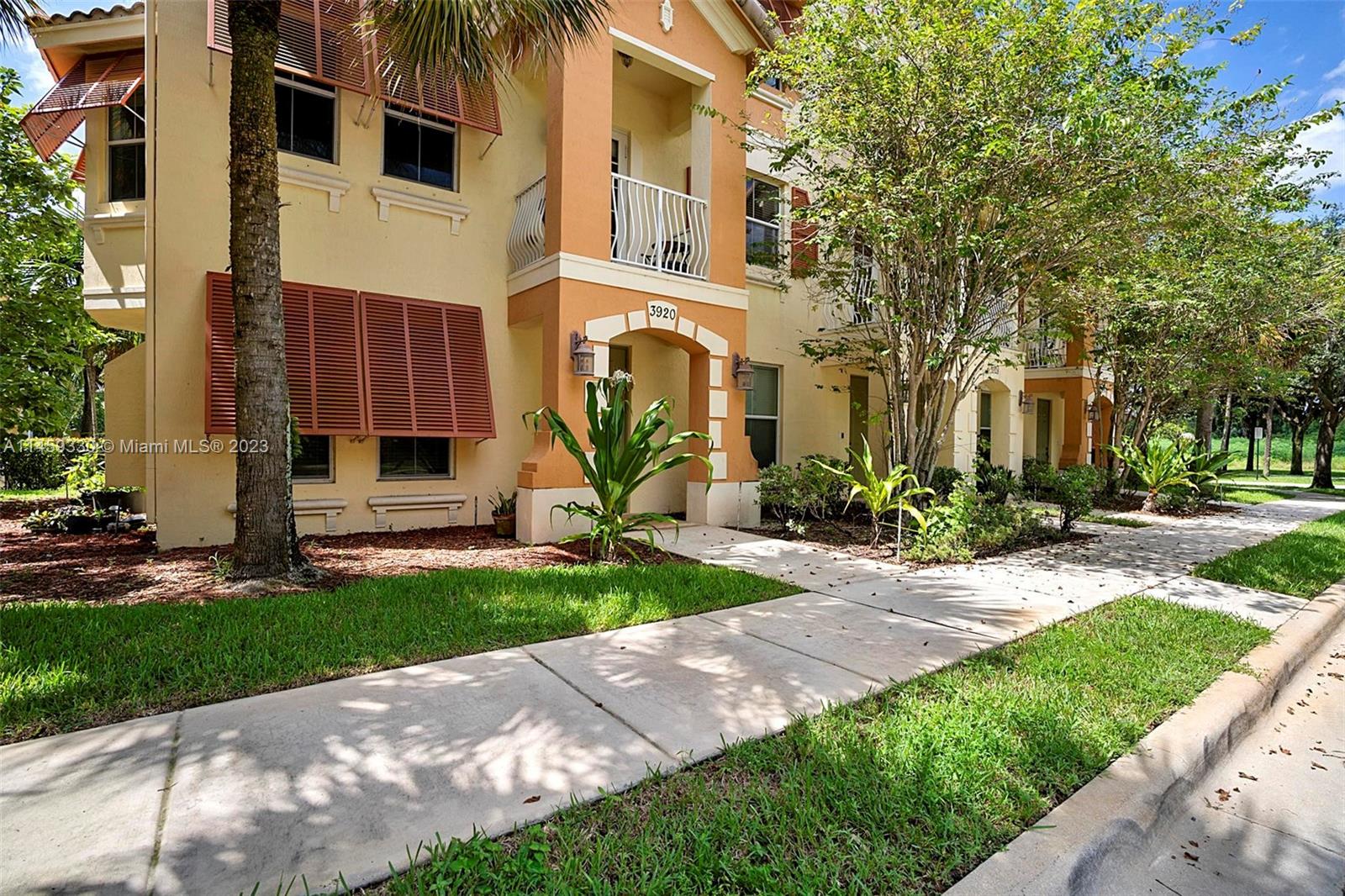 3920 Passion Flower Road Coconut Creek, FL 33073 - Photo 2 of 37 a front view of a house with a yard