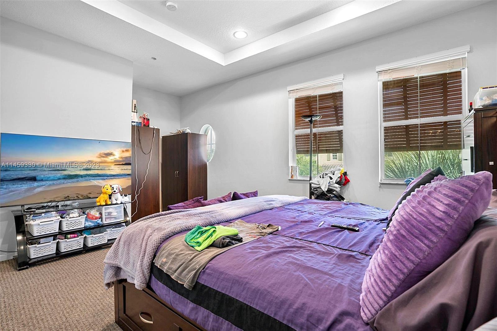 3920 Passion Flower Road Coconut Creek, FL 33073 - Photo 21 of 37 a bedroom with a bed and a large window