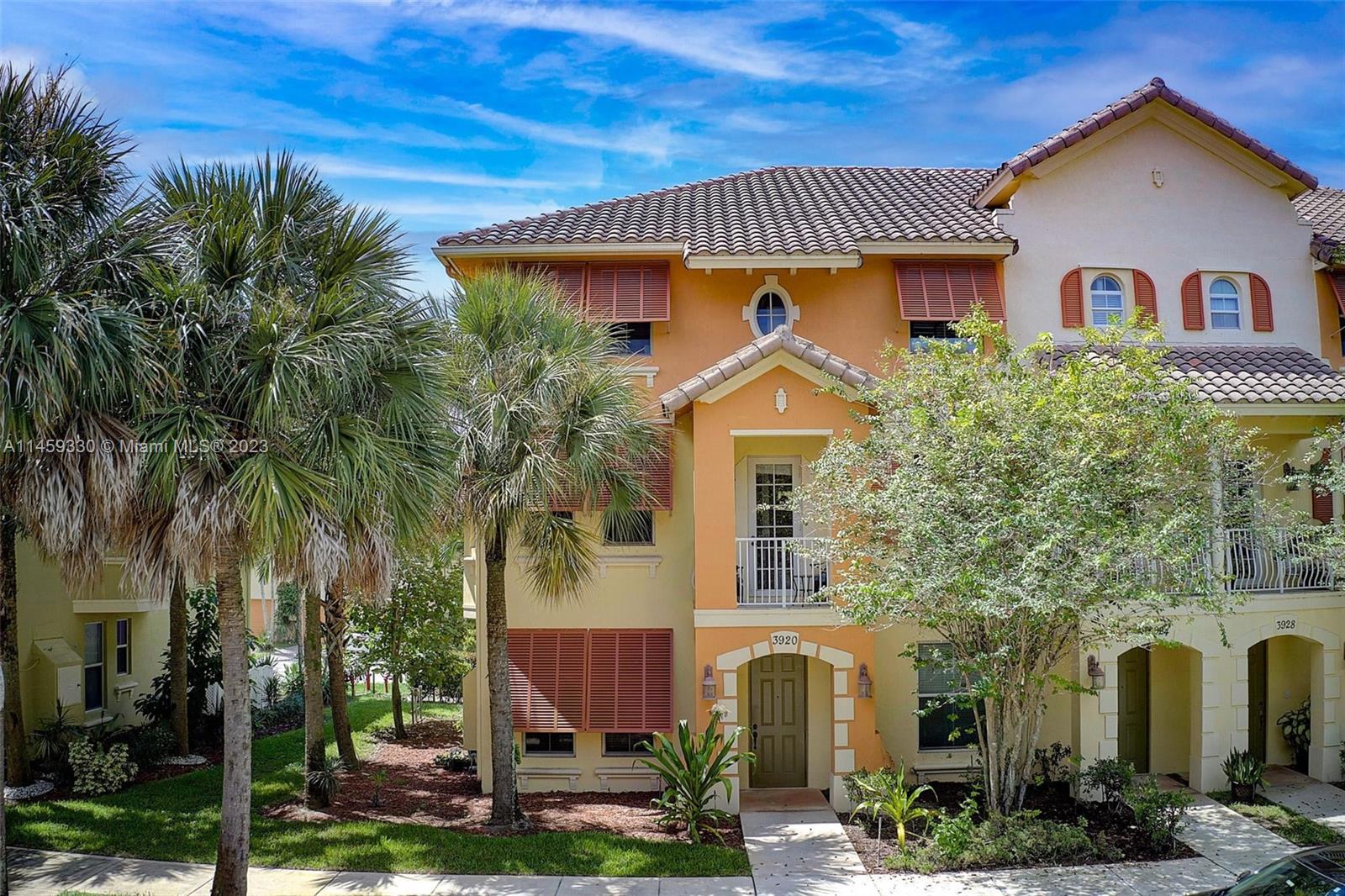 3920 Passion Flower Road Coconut Creek, FL 33073 - Photo 27 of 37 front view of a house with a yard