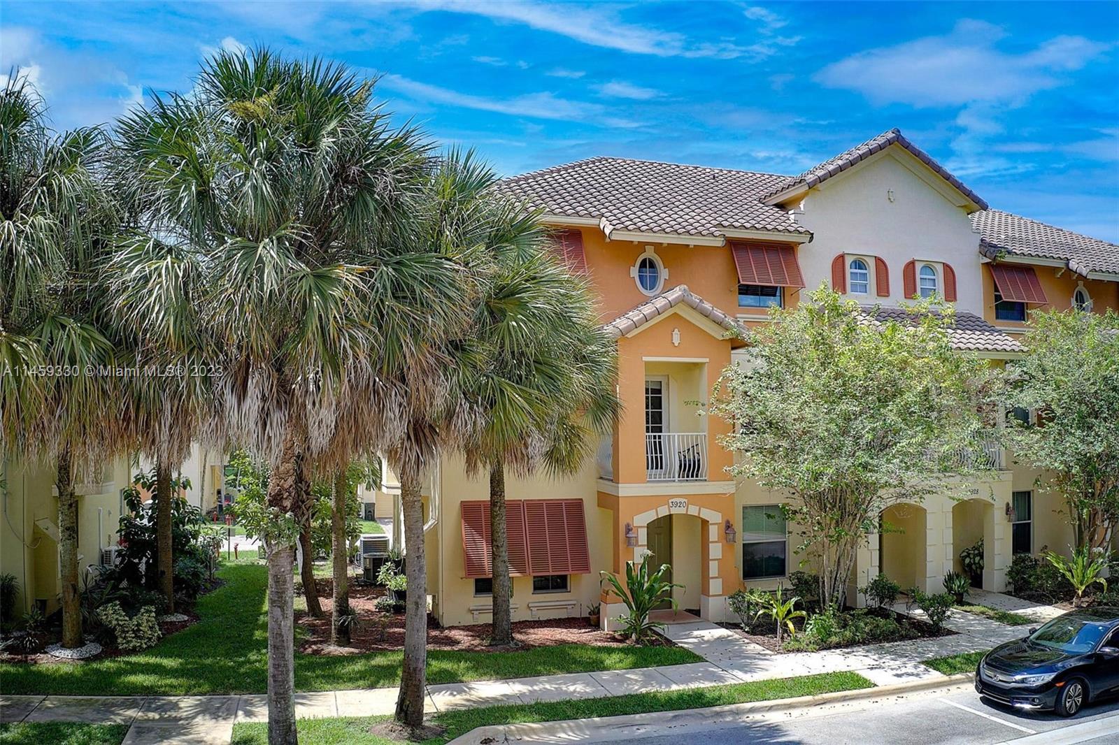 3920 Passion Flower Road Coconut Creek, FL 33073 - Photo 28 of 37 a front view of house with yard and green space