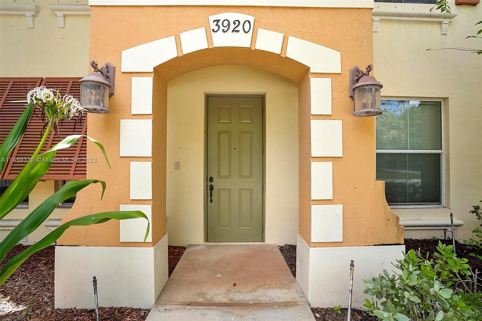 3920 Passion Flower Road Coconut Creek, FL 33073 - Photo 3 of 37 a front view of a house with a yard