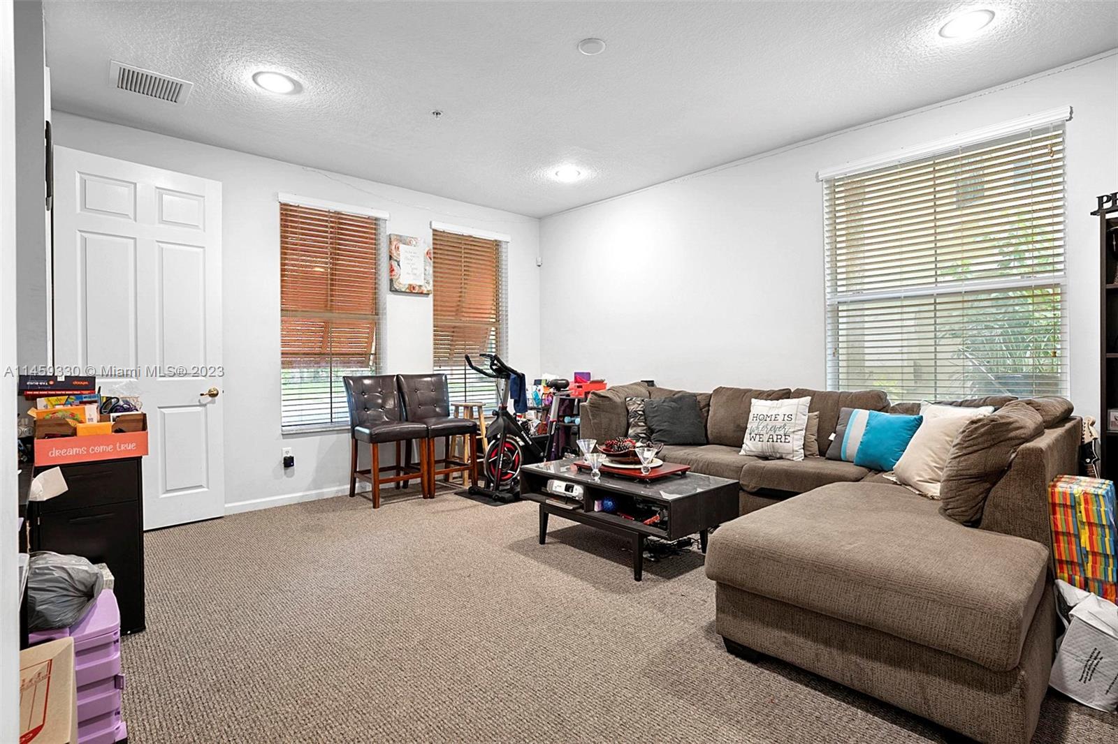 3920 Passion Flower Road Coconut Creek, FL 33073 - Photo 5 of 37 a living room with furniture and a window