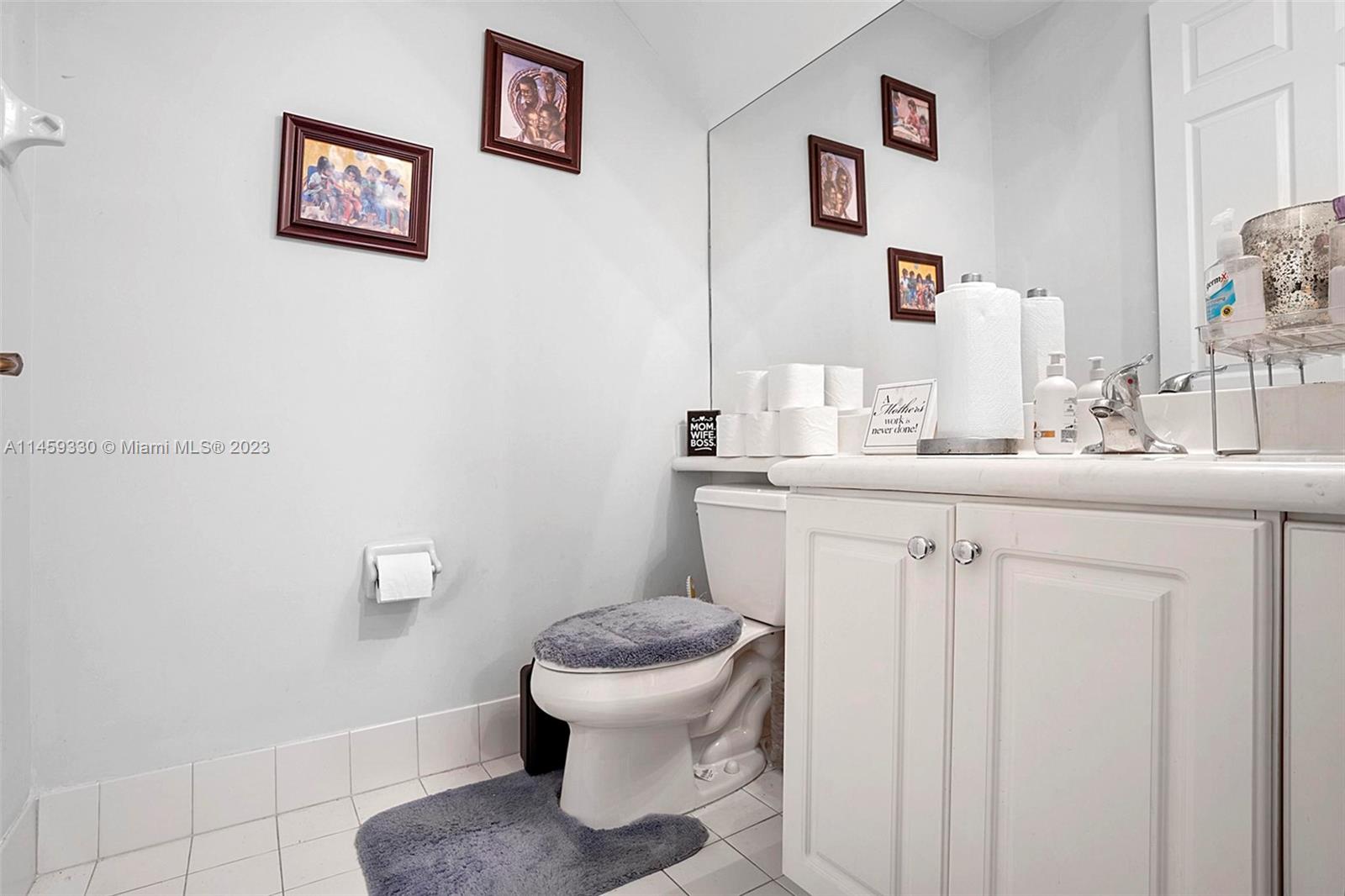 3920 Passion Flower Road Coconut Creek, FL 33073 - Photo 6 of 37 a bathroom with a toilet sink and mirror