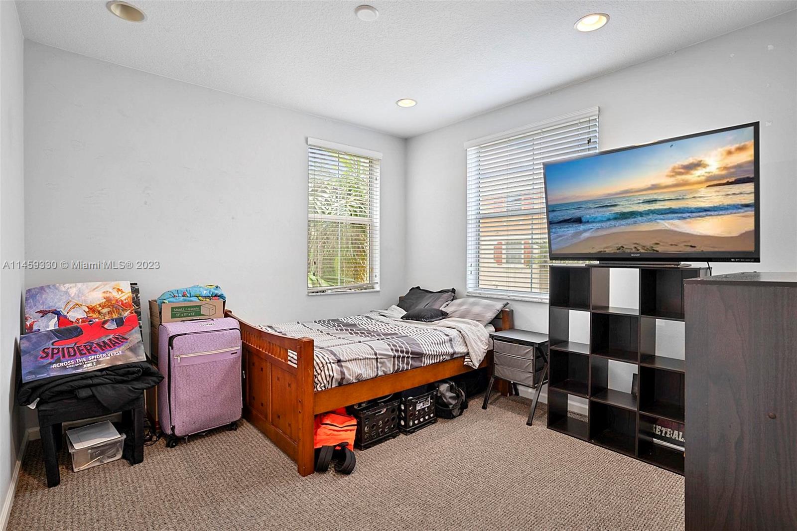 3920 Passion Flower Road Coconut Creek, FL 33073 - Photo 7 of 37 a bedroom with a bed and window