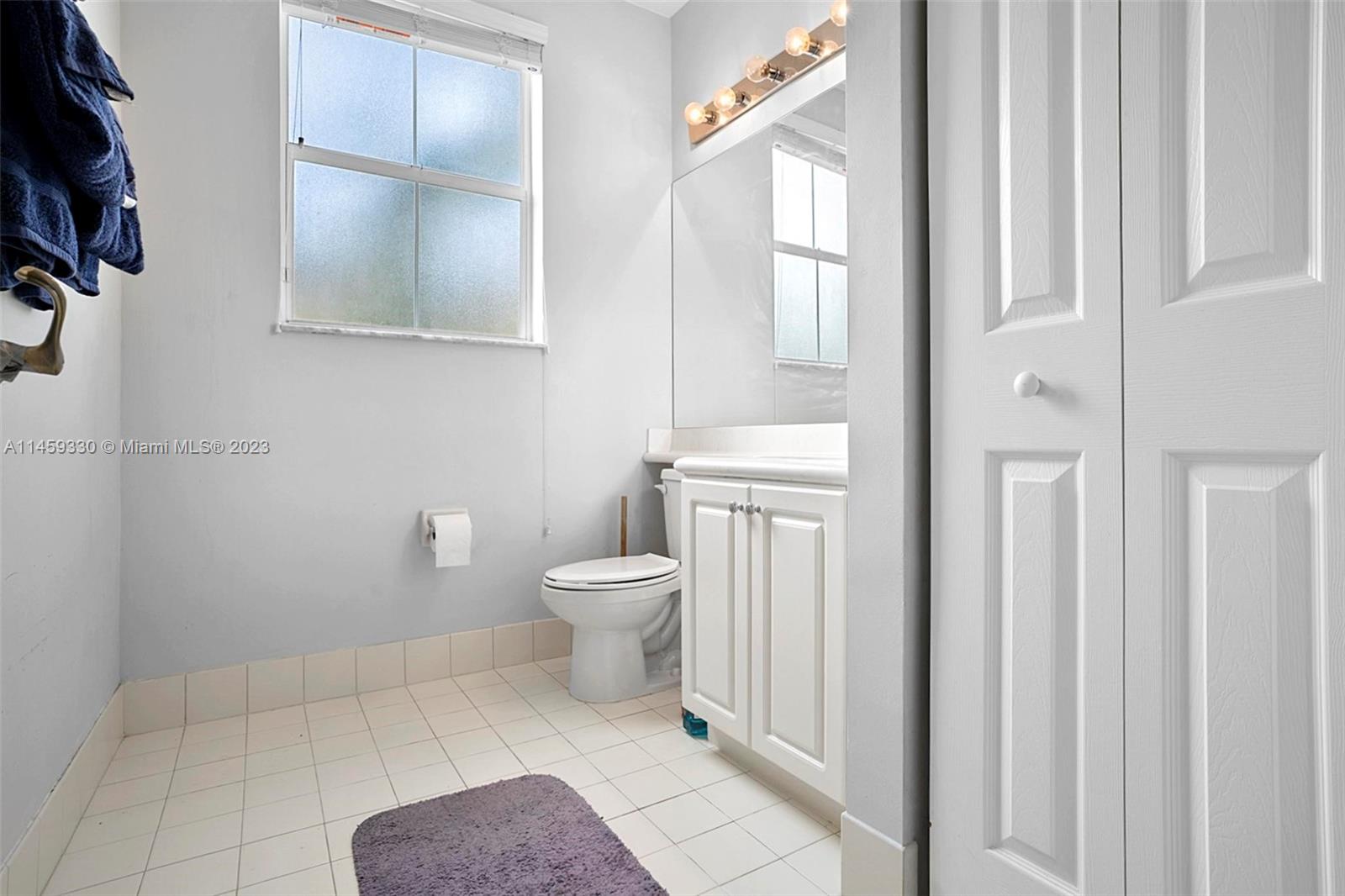 3920 Passion Flower Road Coconut Creek, FL 33073 - Photo 8 of 37 a white toilet sitting next to a bathroom sink