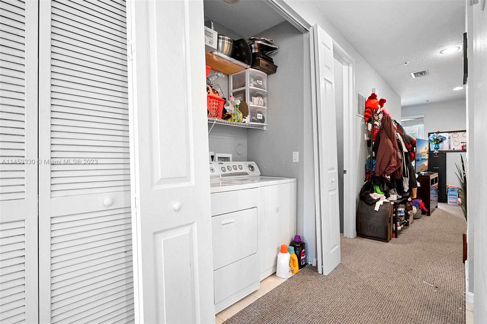 3920 Passion Flower Road Coconut Creek, FL 33073 - Photo 9 of 37 a view of walk in closet with clothes and shoes