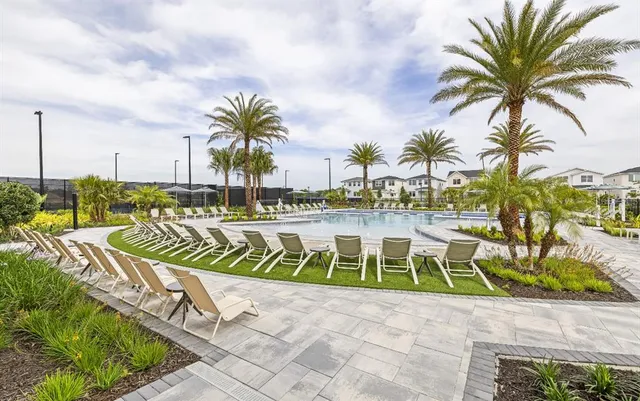 a view of swimming pool with outdoor seating and yard in back