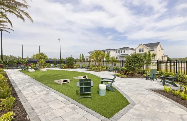 a tennis court that has potted plants